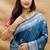 Teal blue silk blend banarasi saree with silver zari border and peacock pallu