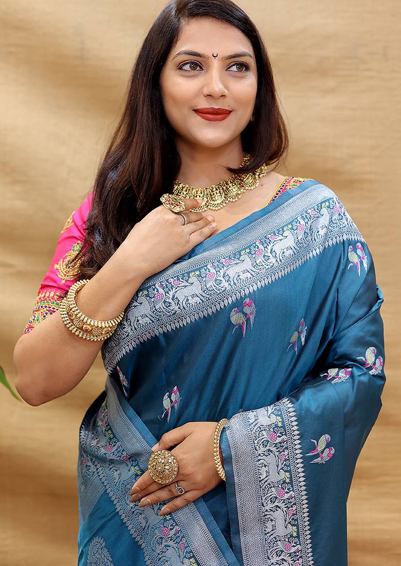 Teal blue silk blend banarasi saree with silver zari border and peacock pallu