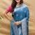 Teal blue silk blend banarasi saree with silver zari border and peacock pallu