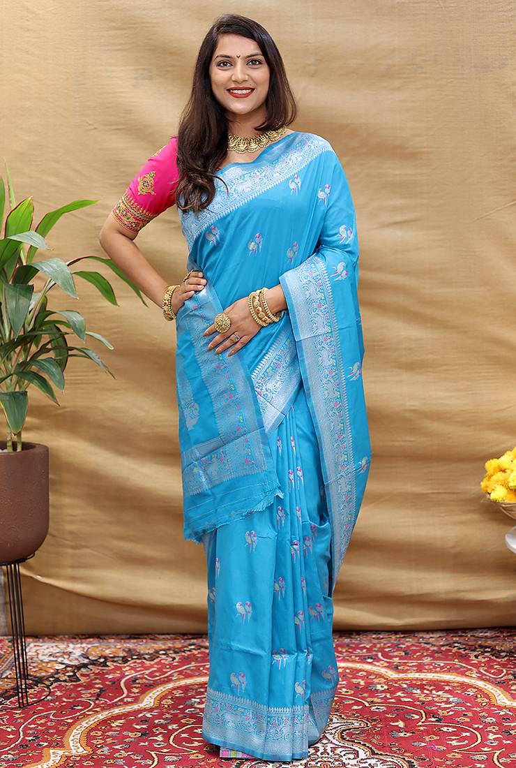 Sky blue silk blend banarasi saree with silver zari border and peacock pallu