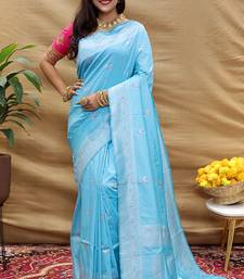 Sky blue silk blend banarasi saree with silver zari border and peacock pallu