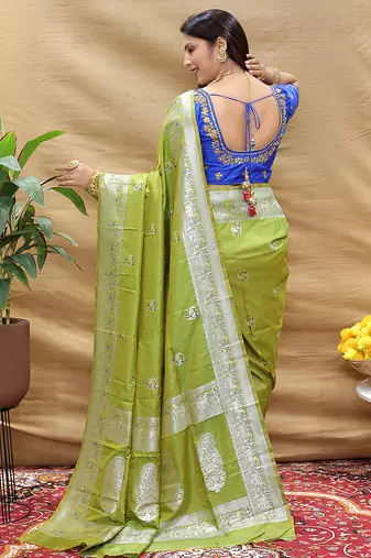 Light olive silk blend banarasi saree with silver zari border and peacock pallu