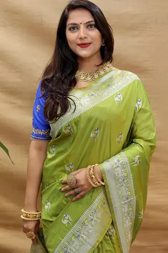 Light olive silk blend banarasi saree with silver zari border and peacock pallu