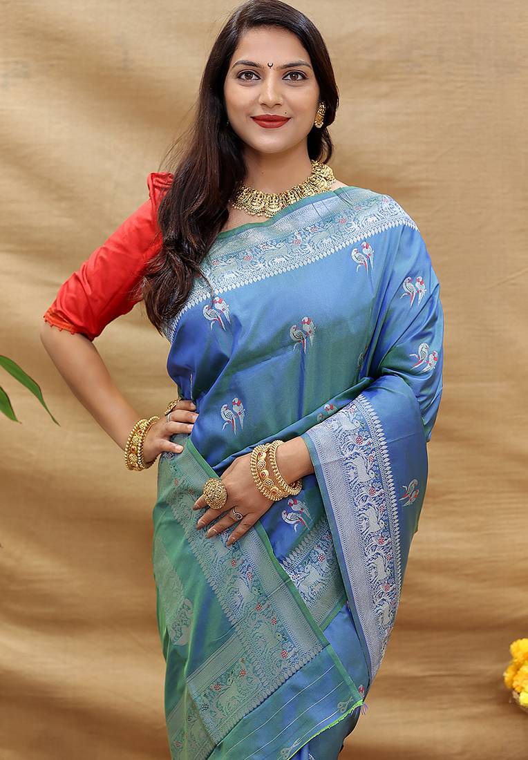 Blue silk blend banarasi saree with silver zari border and peacock pallu