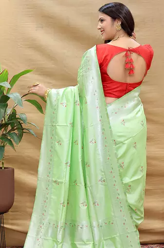 Mint green silk blend banarasi saree with silver zari border and peacock pallu