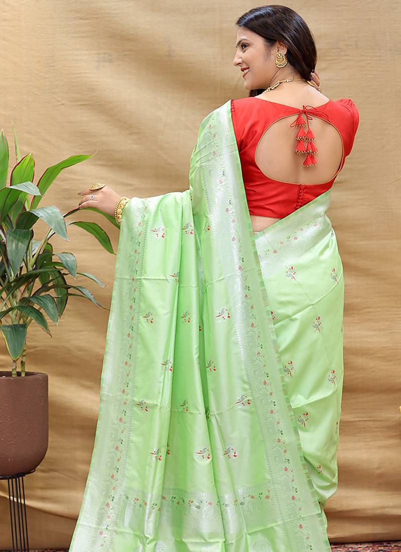 Mint green silk blend banarasi saree with silver zari border and peacock pallu