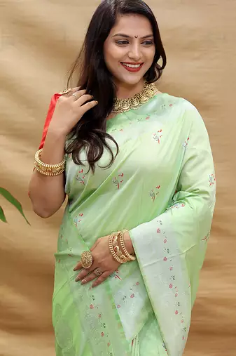 Mint green silk blend banarasi saree with silver zari border and peacock pallu