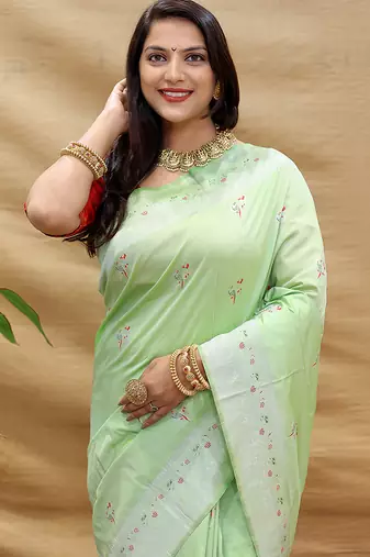 Mint green silk blend banarasi saree with silver zari border and peacock pallu