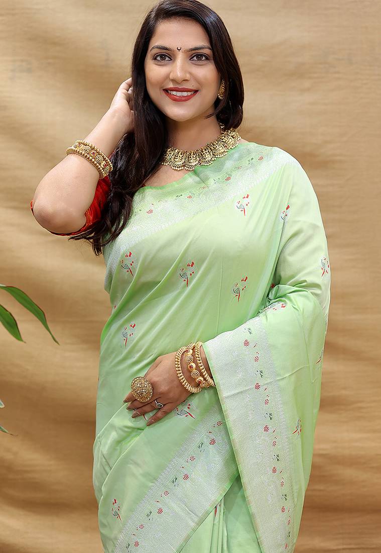 Mint green silk blend banarasi saree with silver zari border and peacock pallu