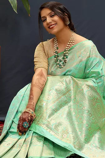 Mint green silk blend banarasi saree with all-over gold zari jaal work