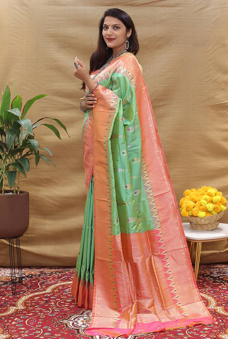 Mint green banarasi silk blend saree with peach zari woven border