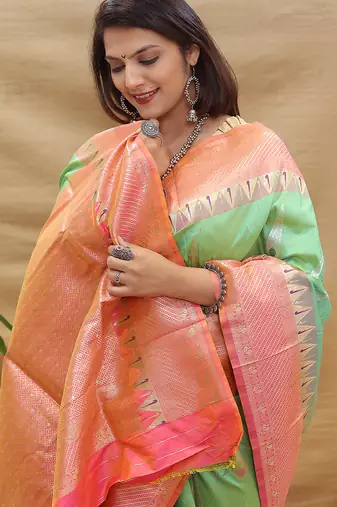 Mint green banarasi silk blend saree with peach zari woven border