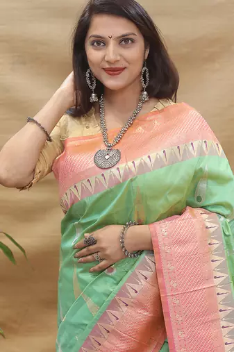 Mint green banarasi silk blend saree with peach zari woven border