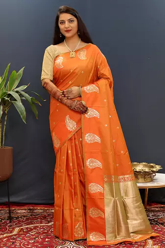 Orange silk blend banarasi saree with golden zari buti and border