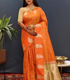 Orange silk blend banarasi saree with golden zari buti and border