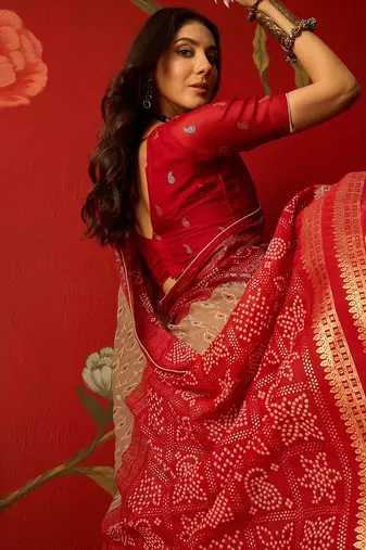 Beige georgette bandhni printed saree with unstitched blouse piece.