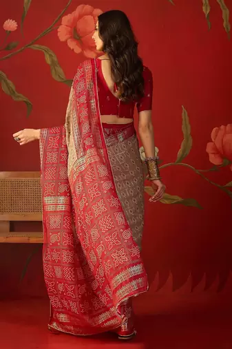 Beige georgette bandhni printed saree with unstitched blouse piece.