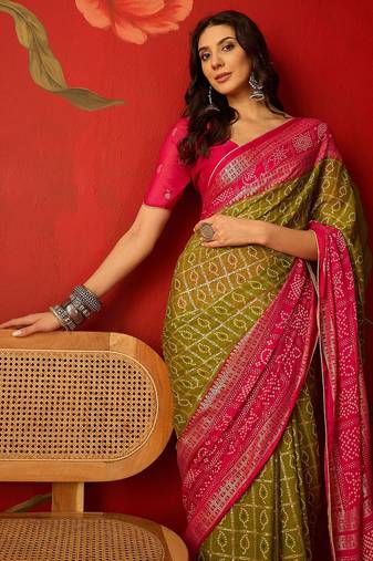 Green georgette bandhni printed saree with unstitched blouse piece.