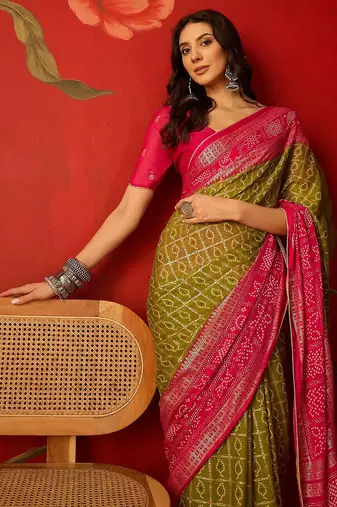 Green georgette bandhni printed saree with unstitched blouse piece.