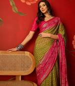 Green georgette bandhni printed saree with unstitched blouse piece.