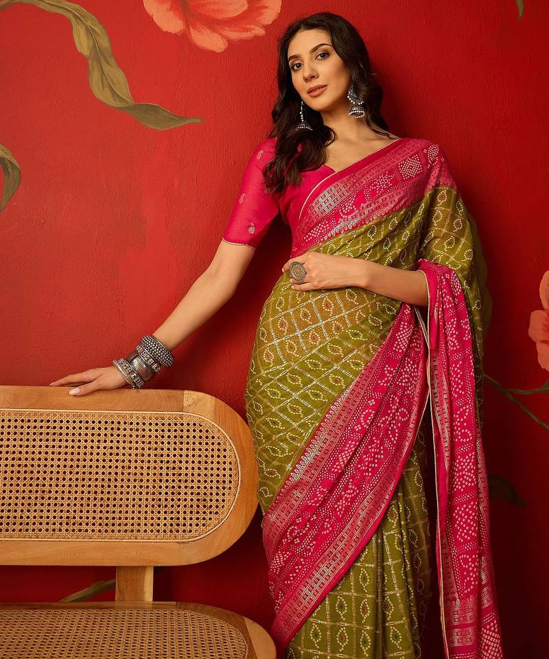 Green georgette bandhni printed saree with unstitched blouse piece.