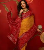 Mustard georgette bandhni printed saree with unstitched blouse piece.