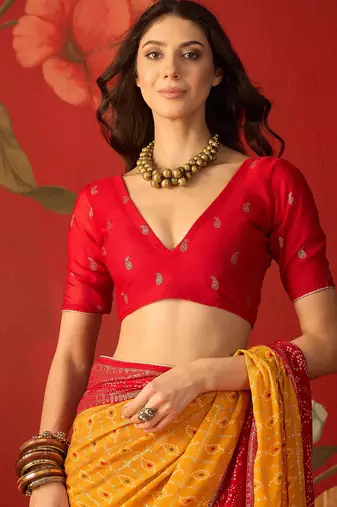 Mustard georgette bandhni printed saree with unstitched blouse piece.