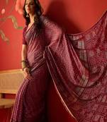 Onion georgette bandhni printed saree with unstitched blouse piece.
