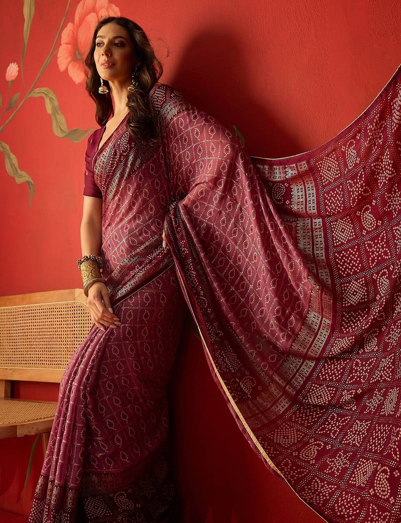 Onion georgette bandhni printed saree with unstitched blouse piece.