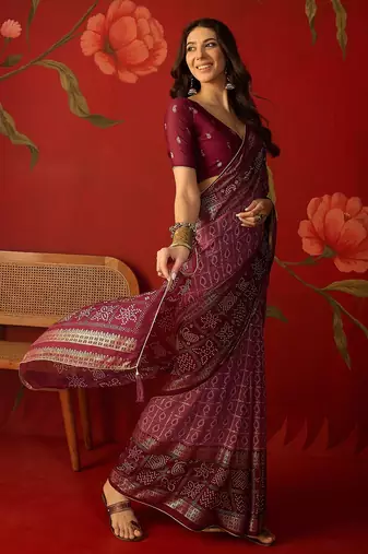 Onion georgette bandhni printed saree with unstitched blouse piece.