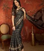 Black silk cotton bandhni saree with unstitched blouse piece.