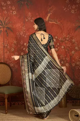 Black silk cotton bandhni saree with unstitched blouse piece.