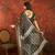 Black silk cotton bandhni saree with unstitched blouse piece.