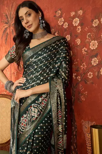 Green silk cotton bandhni saree with unstitched blouse piece.