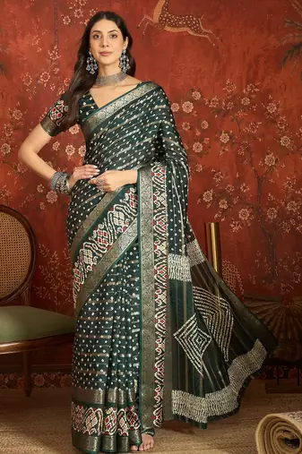 Green silk cotton bandhni saree with unstitched blouse piece.