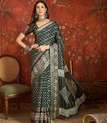 Green silk cotton bandhni saree with unstitched blouse piece.