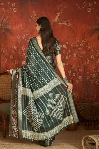 Green silk cotton bandhni saree with unstitched blouse piece.