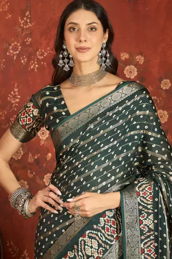 Green silk cotton bandhni saree with unstitched blouse piece.