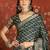 Green silk cotton bandhni saree with unstitched blouse piece.