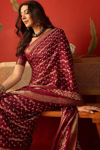 Maroon silk cotton bandhni saree with unstitched blouse piece.