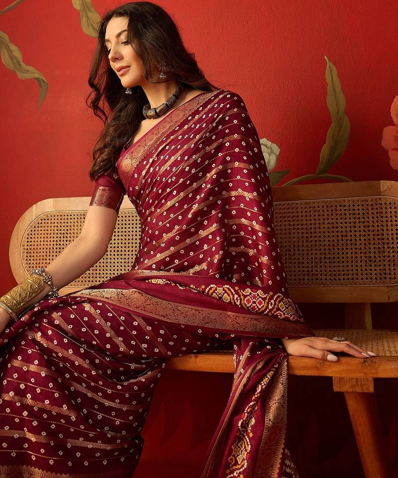 Maroon silk cotton bandhni saree with unstitched blouse piece.