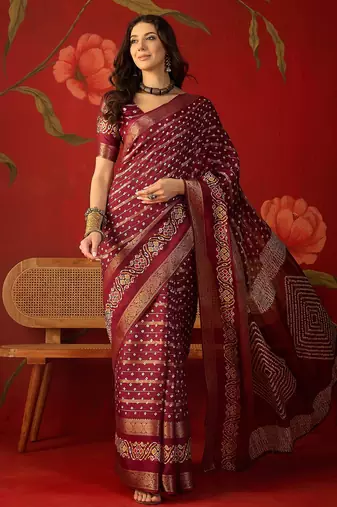 Maroon silk cotton bandhni saree with unstitched blouse piece.