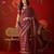 Maroon silk cotton bandhni saree with unstitched blouse piece.