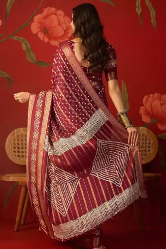 Maroon silk cotton bandhni saree with unstitched blouse piece.