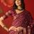 Maroon silk cotton bandhni saree with unstitched blouse piece.