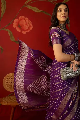 Purple silk cotton bandhni saree with unstitched blouse piece.