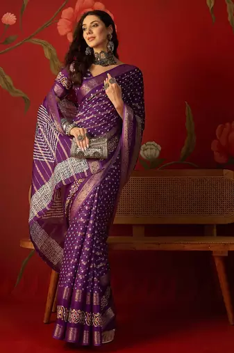 Purple silk cotton bandhni saree with unstitched blouse piece.