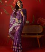 Purple silk cotton bandhni saree with unstitched blouse piece.