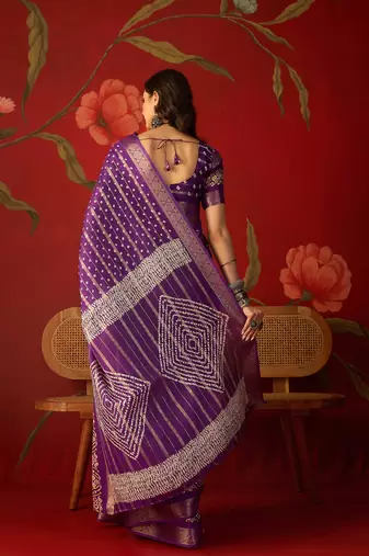 Purple silk cotton bandhni saree with unstitched blouse piece.