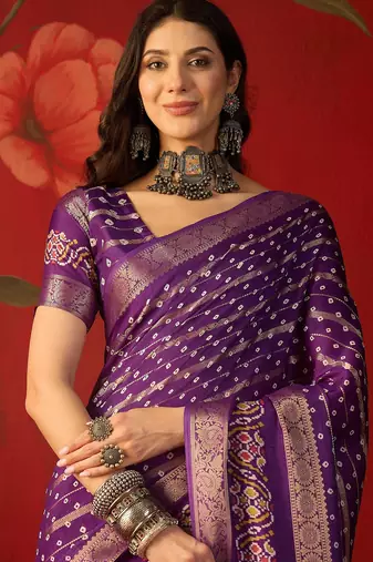 Purple silk cotton bandhni saree with unstitched blouse piece.